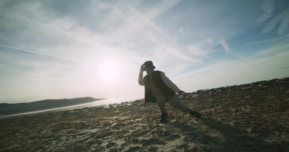 A man is dancing and waving his arms