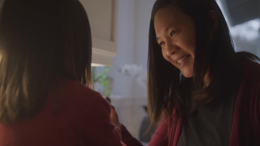 A child helps her mother cook in a cozy kitchen at home