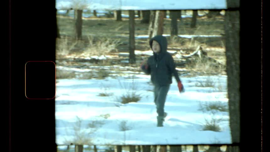 A clip of a boy playing out in the snow