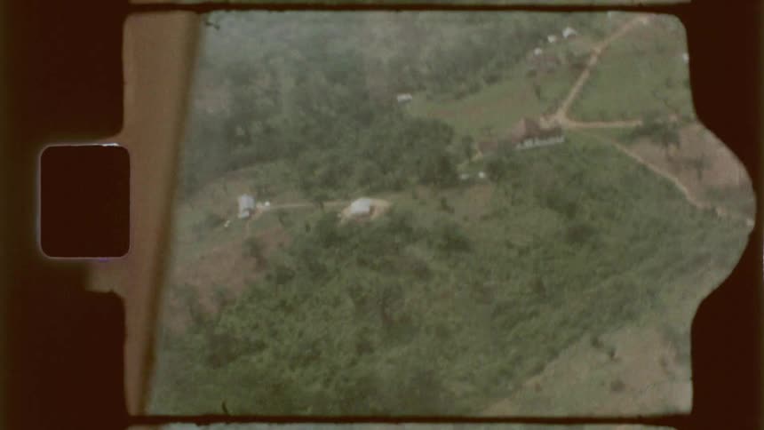 Aerial view from an airplane window over a forested area