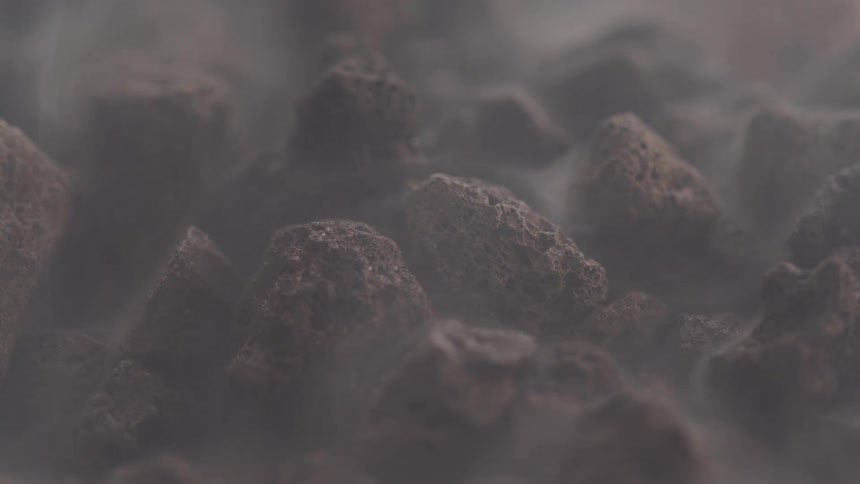 Close up of small stones emerging from abstract steam