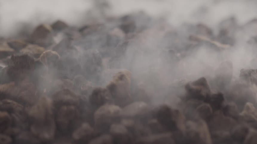 Smoke moves over rocks as they bounce up and down