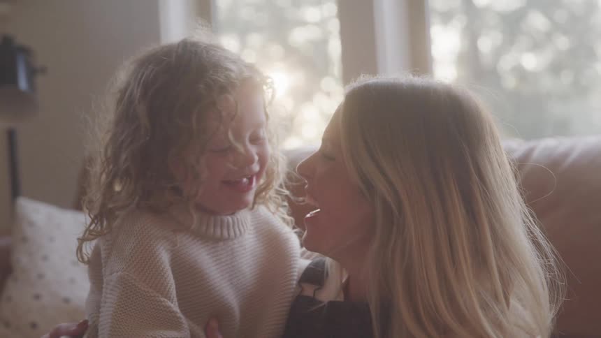 A mother and daughter are laughing together