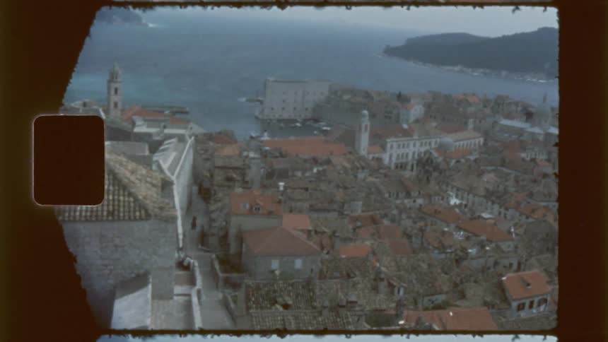 A city on the water is seen from the top of a castle
