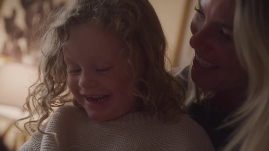 A mother and daughter are laughing together