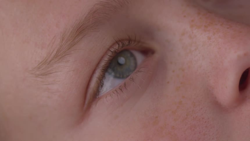 Blonde woman opening her eyes
