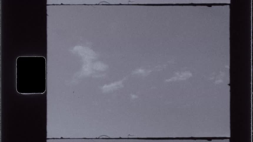A white blurred object seen through an old flickering image