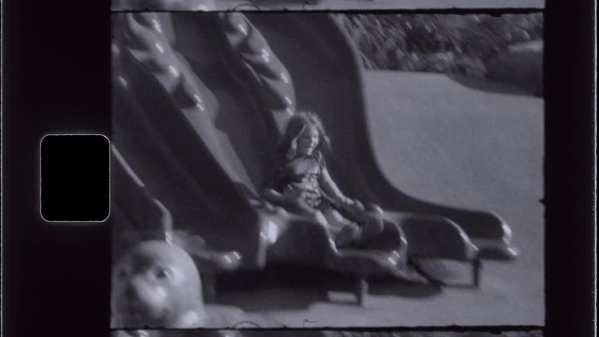 Child outdoors going down a slide
