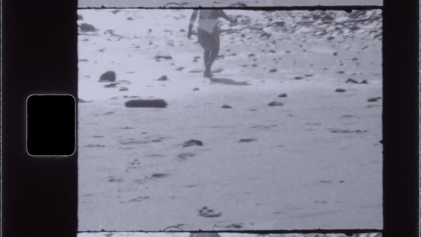 Legs of a person walking on the sand at the beach