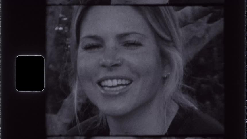 A woman is smiling and scrunching her nose to be silly
