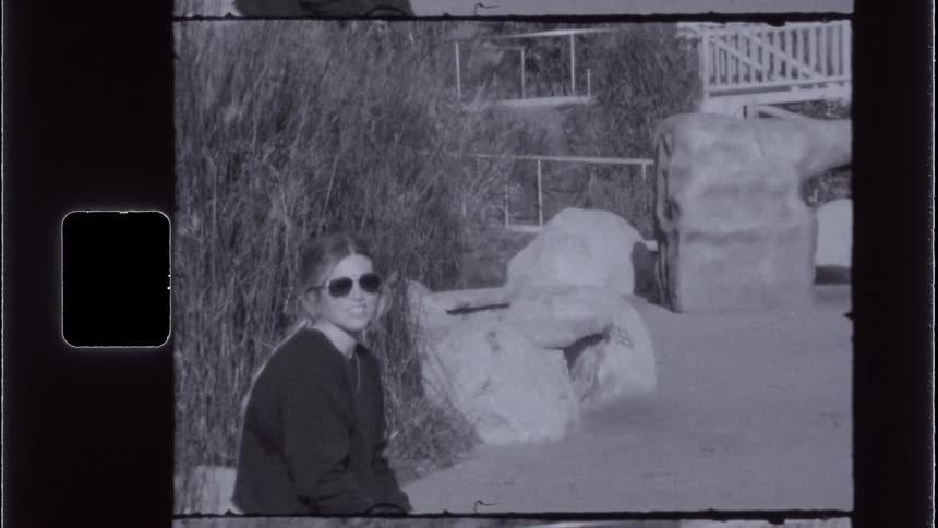 Woman wearing sunglasses sitting outdoors