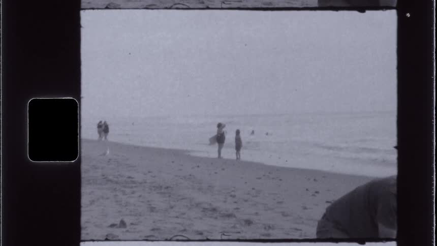 People enjoy the beach on a foggy day
