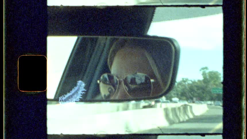 A woman is driving on the highway on a cloudy day