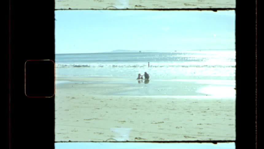 A family plays in the sand and water on the beach