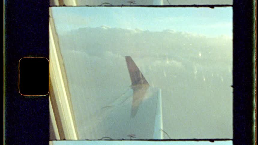 The view from an airplane window capturing the aircrafts wing and winglet against a backdrop of clouds and a clear sky