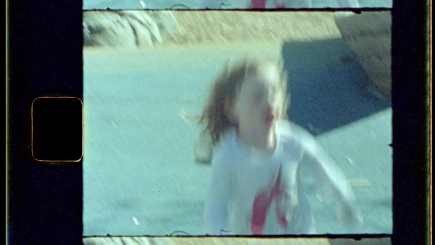 Redheaded girl runs across the playground during the daytime