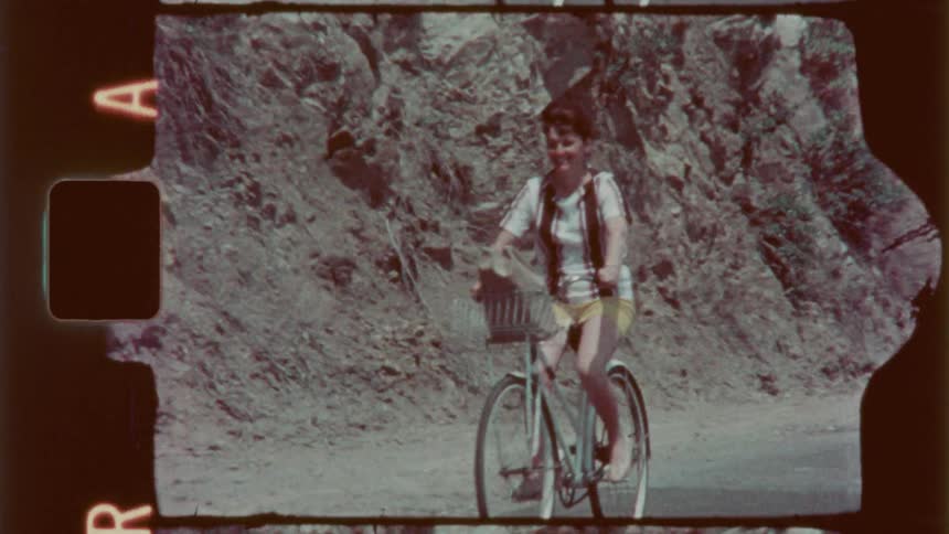 A woman is riding her bicycle