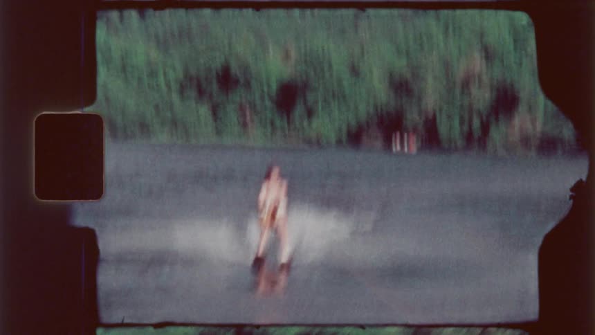 A man water skis on the lake water