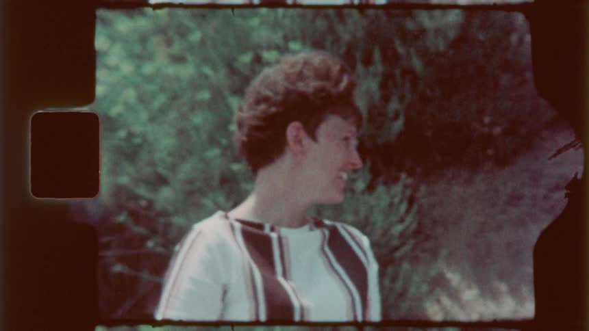 A woman turns around smiling as a golf cart drives by her
