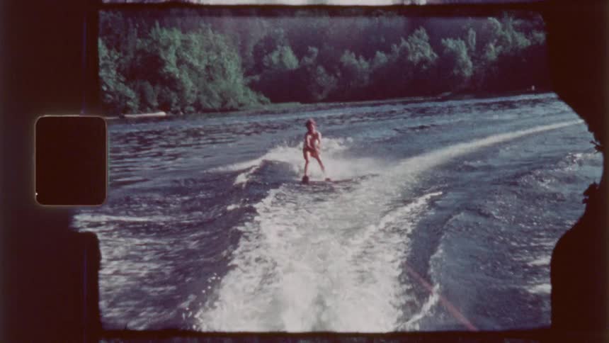 A man is water skiing on a sunny day