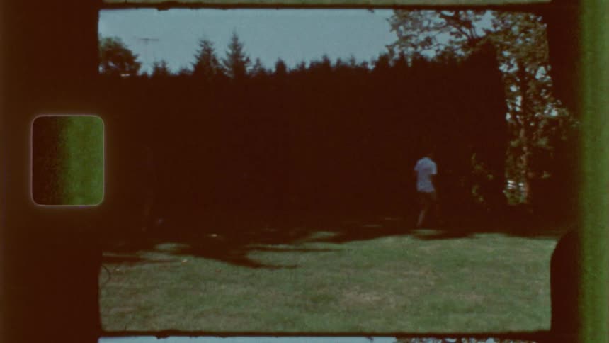 Children in a backyard playing in broad daylight