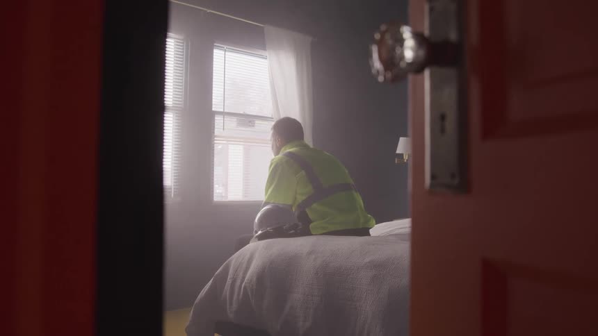 A footage of a person sitting on the bed