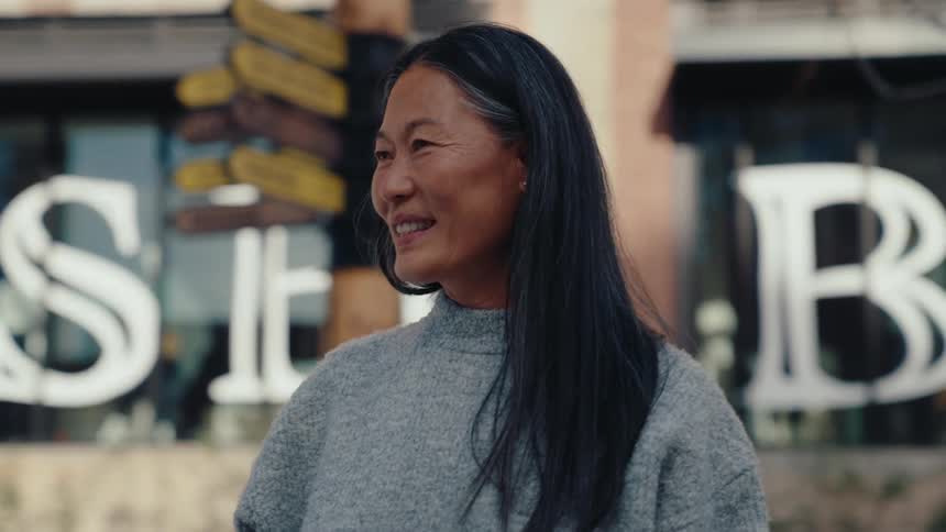 A woman smiles and walks