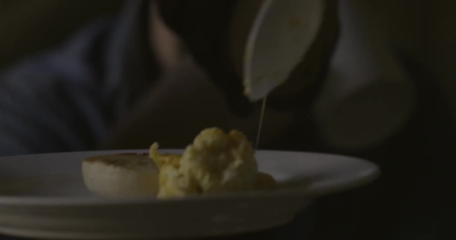 Person scoops eggs onto a plate
