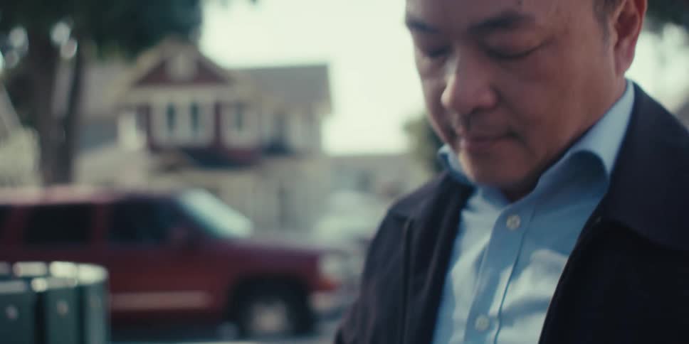 Man in blazer outdoors interacting with a tablet