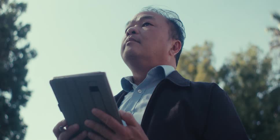 A man using a tablet during the day outdoors