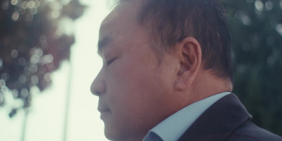 Side portrait of a man in a blazer using a tablet with a digital pen