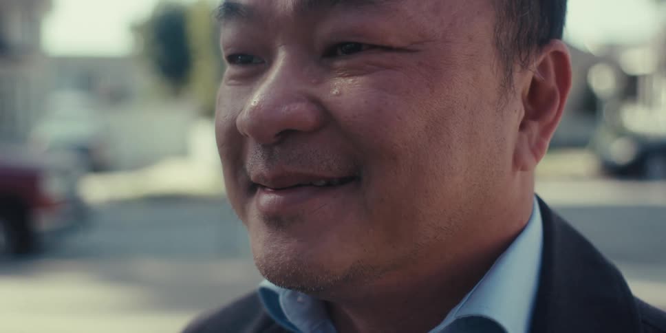 The face of a happy man using a pen to use on the screen of a tablet