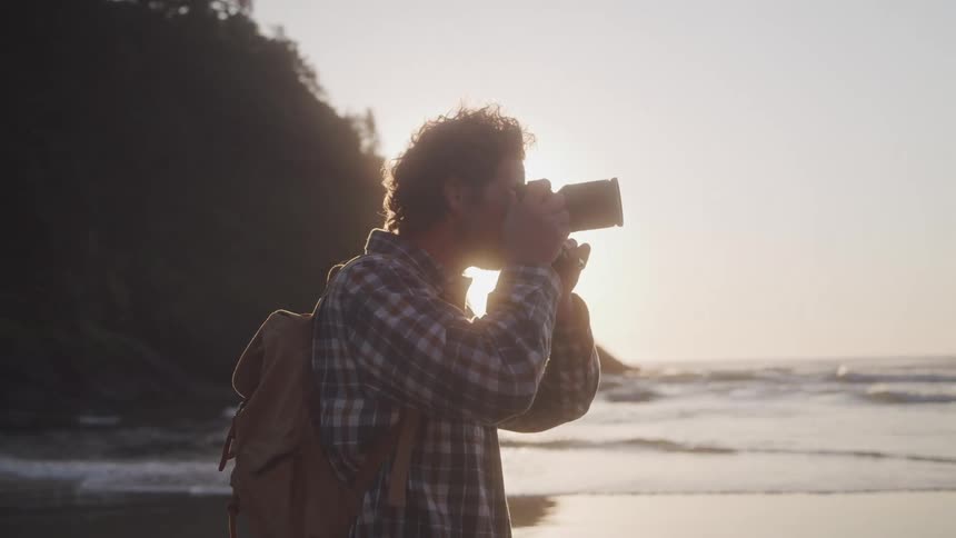 A man is taking photographs of the beach