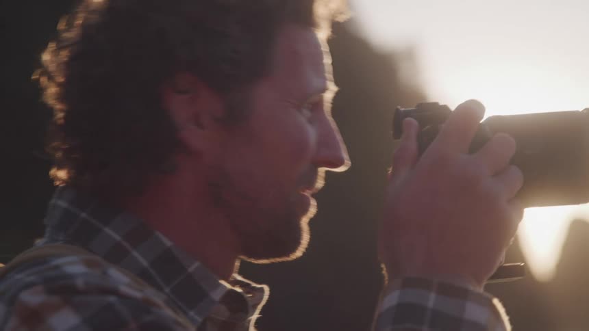 A man is photographing on the beach