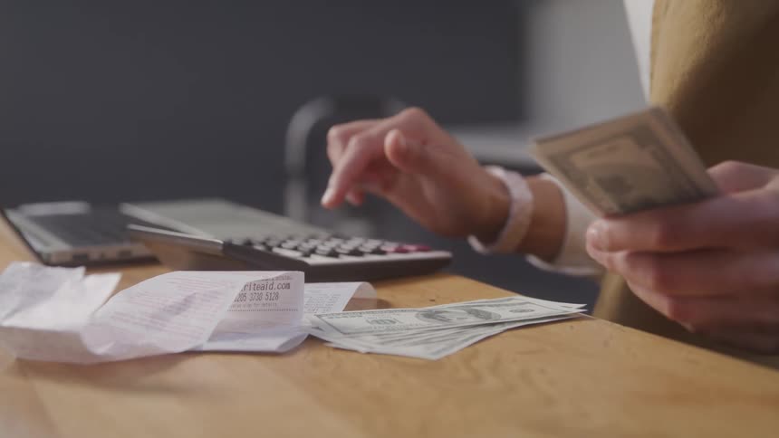 A footage of a person calculating money