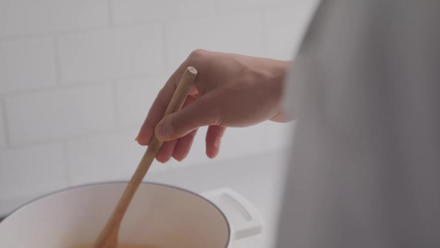 A footage of a person stirring a recipe in a bowl