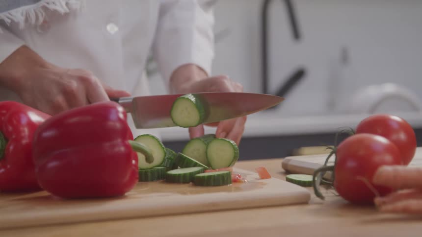 A footage of a chef slicing vegetables