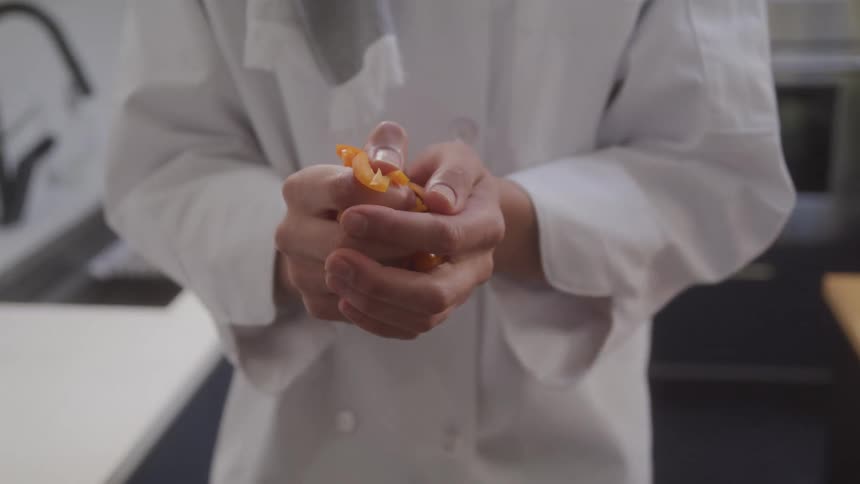 Pair of chefs hands holding sliced vegetables