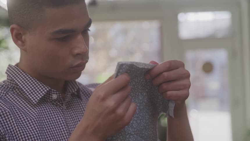 Young man analyzing a fabric