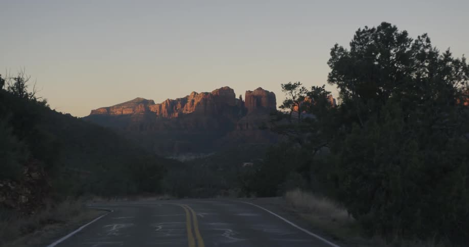 A view of a road like someone is traveling and you see mountains