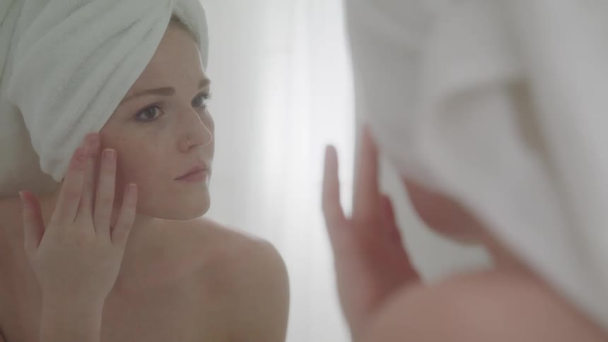 A footage of a lady using the bathroom