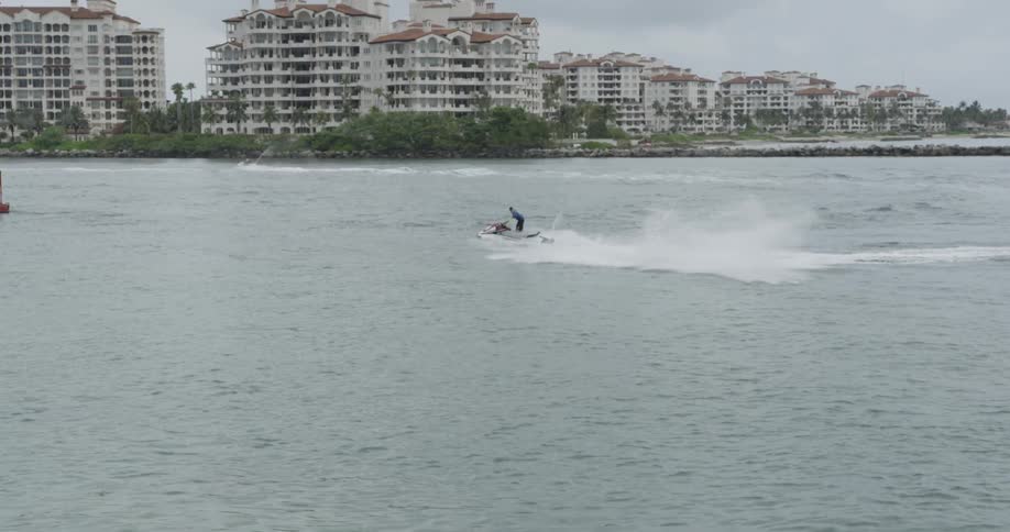 Person riding a jet ski on an ocean bay