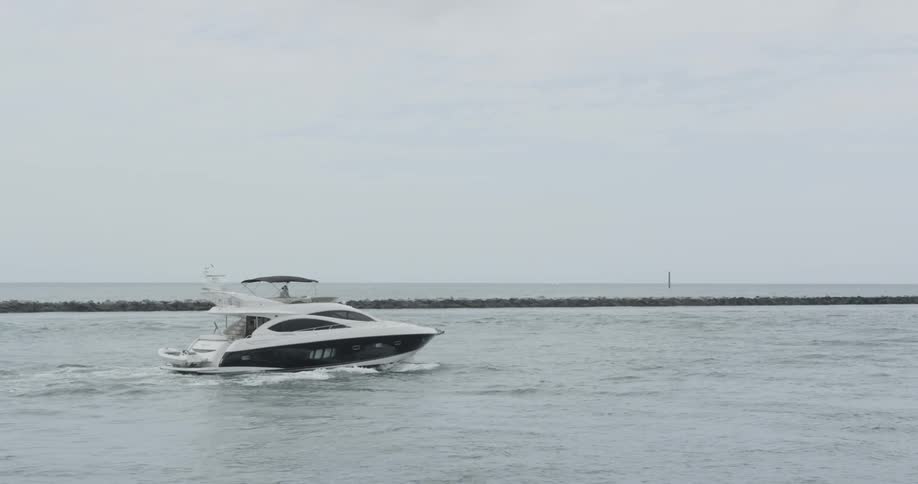 A boat is making its way out of a harbor