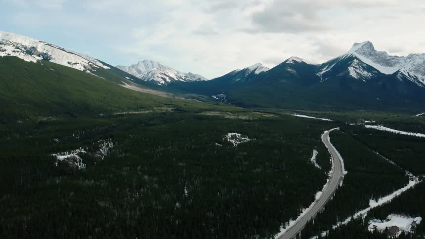 A highway runs through the forest in the Kananaskis valley in Alberta, Canada