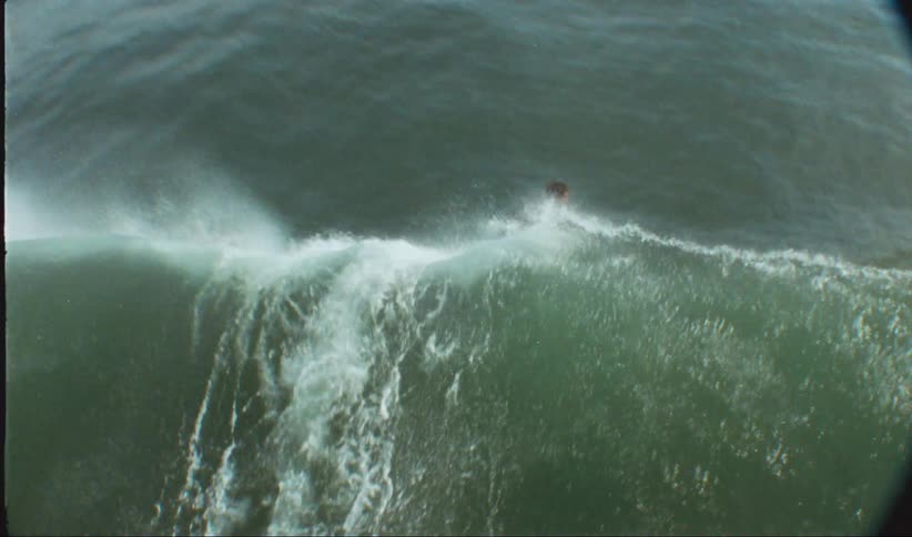 Surfers catching a wave
