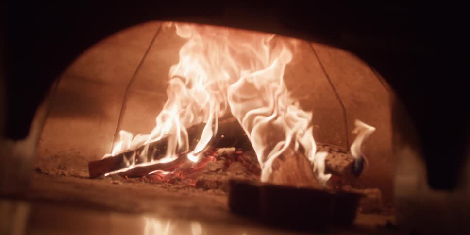 The fireplace is burning in the dark