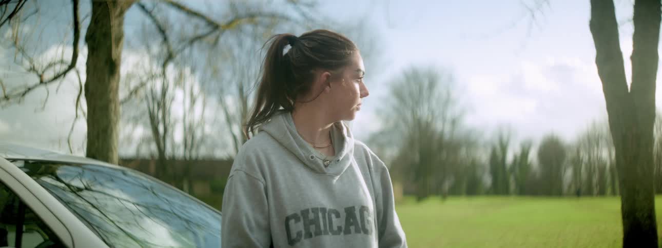 A teenager is looking towards the field