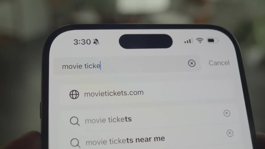 Closeup of a smartphone screen and text being displayed in a search bar
