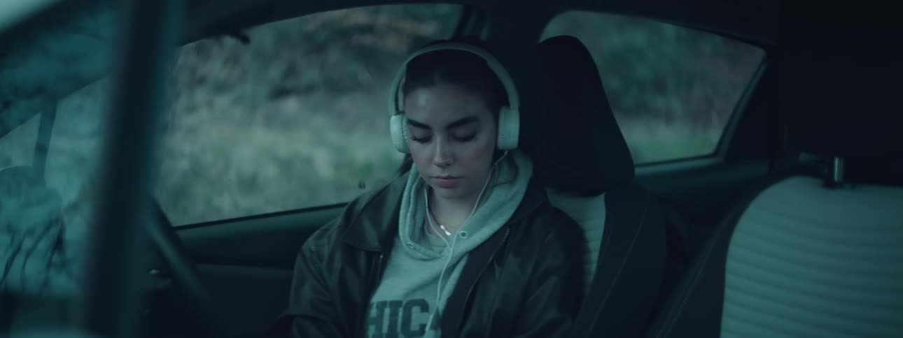 A girl is listening to music in the car