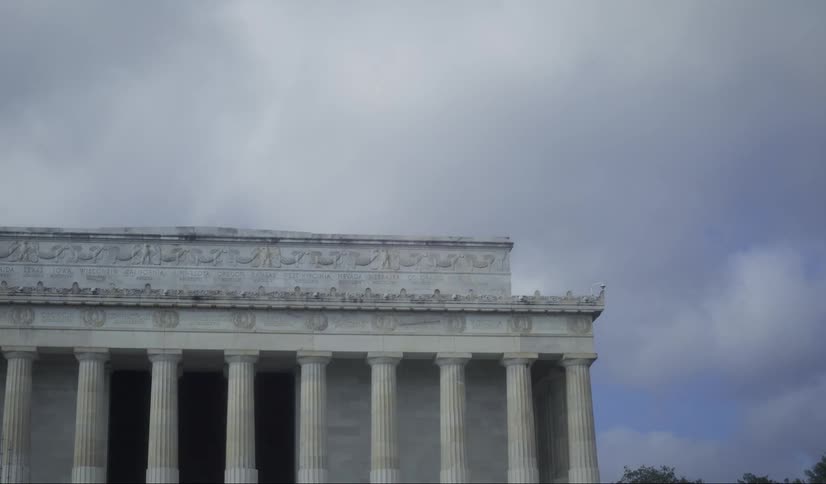 Building with historic and classical architecture with columns against a cloudy sky